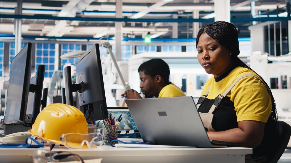 Engineering professionals working with digital systems in an industrial environment