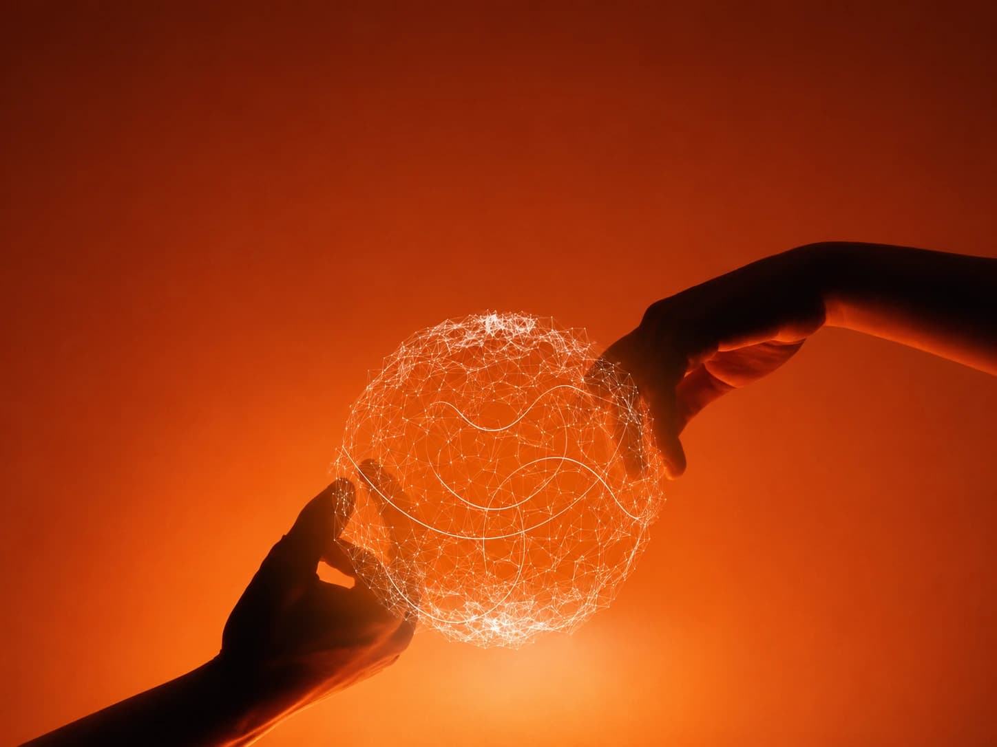 Hands shaping a luminous connected sphere