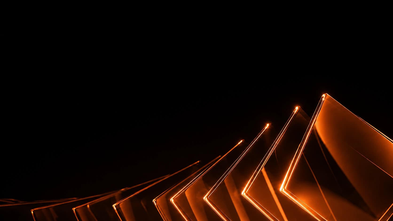 Luminous orange glass forms rising through a dark space